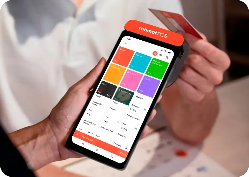 A Rahmat POS terminal in a seller’s hand during a card payment